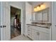 Well-lit bathroom with modern finishes, granite countertops, and view into bedroom at 1201 Peridot Ln, Sun City Center, FL 33573