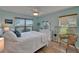 Light and bright bedroom featuring beautiful flooring, a ceiling fan, and ample natural light at 1201 Peridot Ln, Sun City Center, FL 33573