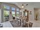 Sunlit dining area features a dining table with seating, and tile flooring at 1201 Peridot Ln, Sun City Center, FL 33573