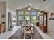 Bright dining room featuring vaulted ceilings, large windows, and a view of the pool area at 1201 Peridot Ln, Sun City Center, FL 33573