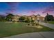 Charming single-story home with a well-manicured lawn and a tile roof at dusk at 1201 Peridot Ln, Sun City Center, FL 33573