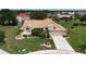Charming single Gathering home with a manicured front yard, mature trees, and a paved driveway at 1201 Peridot Ln, Sun City Center, FL 33573