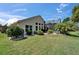 Well-maintained home exterior with a screened pool area and verdant landscaping at 1201 Peridot Ln, Sun City Center, FL 33573