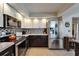 Kitchen with modern appliances, two-tone cabinets, and a view to the dining area at 1201 Peridot Ln, Sun City Center, FL 33573