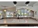 Open kitchen view looking into a bright dining area with a large window offering beautiful backyard views at 1201 Peridot Ln, Sun City Center, FL 33573