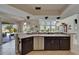 A view from the kitchen features sleek stainless steel appliances and an open concept leading to the dining area and pool at 1201 Peridot Ln, Sun City Center, FL 33573