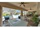 Screened lanai furnished with cozy seating and dining, overlooking the pool and backyard oasis at 1201 Peridot Ln, Sun City Center, FL 33573