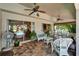Screened lanai features comfortable wicker furniture, ceiling fans, and access to the outdoors at 1201 Peridot Ln, Sun City Center, FL 33573