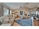 Bright living room with vaulted ceilings, modern decor, and access to the outdoor area at 1201 Peridot Ln, Sun City Center, FL 33573