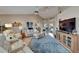 Open living area with comfortable seating, stylish decor, and a large television at 1201 Peridot Ln, Sun City Center, FL 33573
