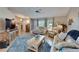 Cozy living room featuring hardwood floors, natural light, and comfortable sofas at 1201 Peridot Ln, Sun City Center, FL 33573