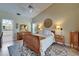 Comfortable main bedroom with vaulted ceiling and natural light from window at 1201 Peridot Ln, Sun City Center, FL 33573