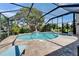 Screened pool with brick patio and mature landscaping offers a private backyard retreat at 1201 Peridot Ln, Sun City Center, FL 33573