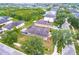 Aerial view showcases home's backyard, lush landscaping, and neighborhood streets at 12202 Fairlawn Dr, Riverview, FL 33579