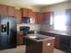 Kitchen features a center island, tile floors and stainless steel appliances at 12202 Fairlawn Dr, Riverview, FL 33579