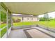 View of the screened in back porch with decorative rug and house in background at 12202 Fairlawn Dr, Riverview, FL 33579
