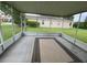 View of a screened in porch with an area rug and a glimpse of the backyard at 12202 Fairlawn Dr, Riverview, FL 33579