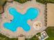 Birds-eye view of the uniquely shaped swimming pool complete with a splash pad and ample lounge seating at 12202 Fairlawn Dr, Riverview, FL 33579