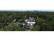 Drone view of the neighborhood, surrounded by mature trees at 1221 E Osborne Ave, Tampa, FL 33603