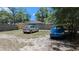 View of the backyard with cars parked, showing the house in the background at 1221 E Osborne Ave, Tampa, FL 33603