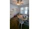 A dining room with a white ceiling fan, a fireplace, and a table with 6 chairs at 1221 E Osborne Ave, Tampa, FL 33603