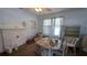 A dining room with a white ceiling fan, a fireplace, and a table with 6 chairs at 1221 E Osborne Ave, Tampa, FL 33603