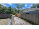 View of the long driveway and fences beside the house at 1221 E Osborne Ave, Tampa, FL 33603