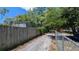 View of a paved driveway and wooden fence leading to the house at 1221 E Osborne Ave, Tampa, FL 33603