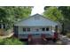 Charming bungalow with a spacious front porch and mature trees offering shade at 1221 E Osborne Ave, Tampa, FL 33603