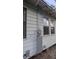 External view showcasing the electrical components and windows of the house at 1221 E Osborne Ave, Tampa, FL 33603