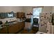 A kitchen featuring outdated cabinets and appliances with a window providing natural light at 1221 E Osborne Ave, Tampa, FL 33603