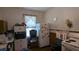 Outdated kitchen with dark cabinetry, old appliances and a window with white curtains at 1221 E Osborne Ave, Tampa, FL 33603