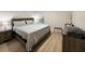 Serene bedroom with a wooden bed frame, cozy duvet, two end tables, and natural light for a relaxing atmosphere at 12223 Kirk Ave, Port Charlotte, FL 33981