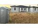 Home construction site with minimal landscaping and portable restroom at 12223 Kirk Ave, Port Charlotte, FL 33981