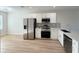Modern kitchen features stainless steel appliances, white cabinetry, and a spacious breakfast bar at 12223 Kirk Ave, Port Charlotte, FL 33981