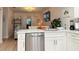 Modern kitchen with white cabinets, stainless steel appliances, and a spacious island for meal preparation and casual dining at 12223 Kirk Ave, Port Charlotte, FL 33981