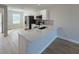 Modern kitchen features stainless steel appliances, white cabinetry, and a spacious breakfast bar at 12223 Kirk Ave, Port Charlotte, FL 33981