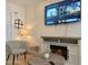 Cozy living room area with a mounted TV, electric fireplace, comfortable seating, and stylish decor creating a relaxing ambiance at 12223 Kirk Ave, Port Charlotte, FL 33981