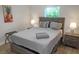 Comfortable bedroom with a full-size bed, wood furniture, and natural light streaming in at 12266 Edwards Rd, Port Charlotte, FL 33981