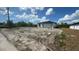 New home featuring a two-car garage in an undeveloped neighborhood under a partially cloudy sky at 12266 Edwards Rd, Port Charlotte, FL 33981
