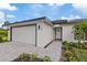 Attractive single-story home featuring a garage, well-kept lawn, and modern architectural details at 12266 Edwards Rd, Port Charlotte, FL 33981