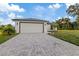 Attractive single-story home featuring a garage, well-kept lawn, and modern architectural details at 12266 Edwards Rd, Port Charlotte, FL 33981