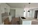 Bright kitchen with island sink, white cabinetry, and stainless steel appliances awaiting finishing touches at 12266 Edwards Rd, Port Charlotte, FL 33981