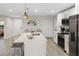 Contemporary kitchen featuring stainless steel appliances, sleek white cabinetry, and a central island at 12266 Edwards Rd, Port Charlotte, FL 33981