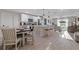 Open concept kitchen featuring a large island, stainless steel appliances, and an adjacent dining area at 12266 Edwards Rd, Port Charlotte, FL 33981