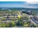 Aerial view of the neighborhood with the property indicated by a bright yellow arrow at 1249 Abbey Crescent Ln, Clearwater, FL 33759