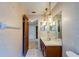 Well-lit bathroom featuring a vanity with decorative lighting fixtures and tile flooring at 1249 Abbey Crescent Ln, Clearwater, FL 33759