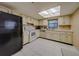 This bright kitchen is equipped with essential appliances and ample cabinet space for storage at 1249 Abbey Crescent Ln, Clearwater, FL 33759