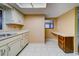 Bright kitchen features white cabinets, tile floors, lots of counter space, and natural light at 1249 Abbey Crescent Ln, Clearwater, FL 33759