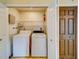 Convenient laundry closet features a washer, dryer, wire shelving, and a fire extinguisher at 1249 Abbey Crescent Ln, Clearwater, FL 33759
